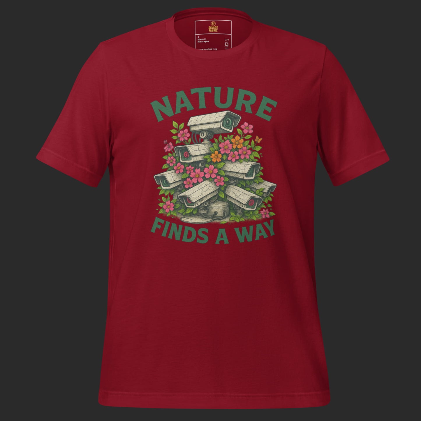 Cardinal red Nature Finds a Way t-shirt with protest graphic of flowers breaking through surveillance