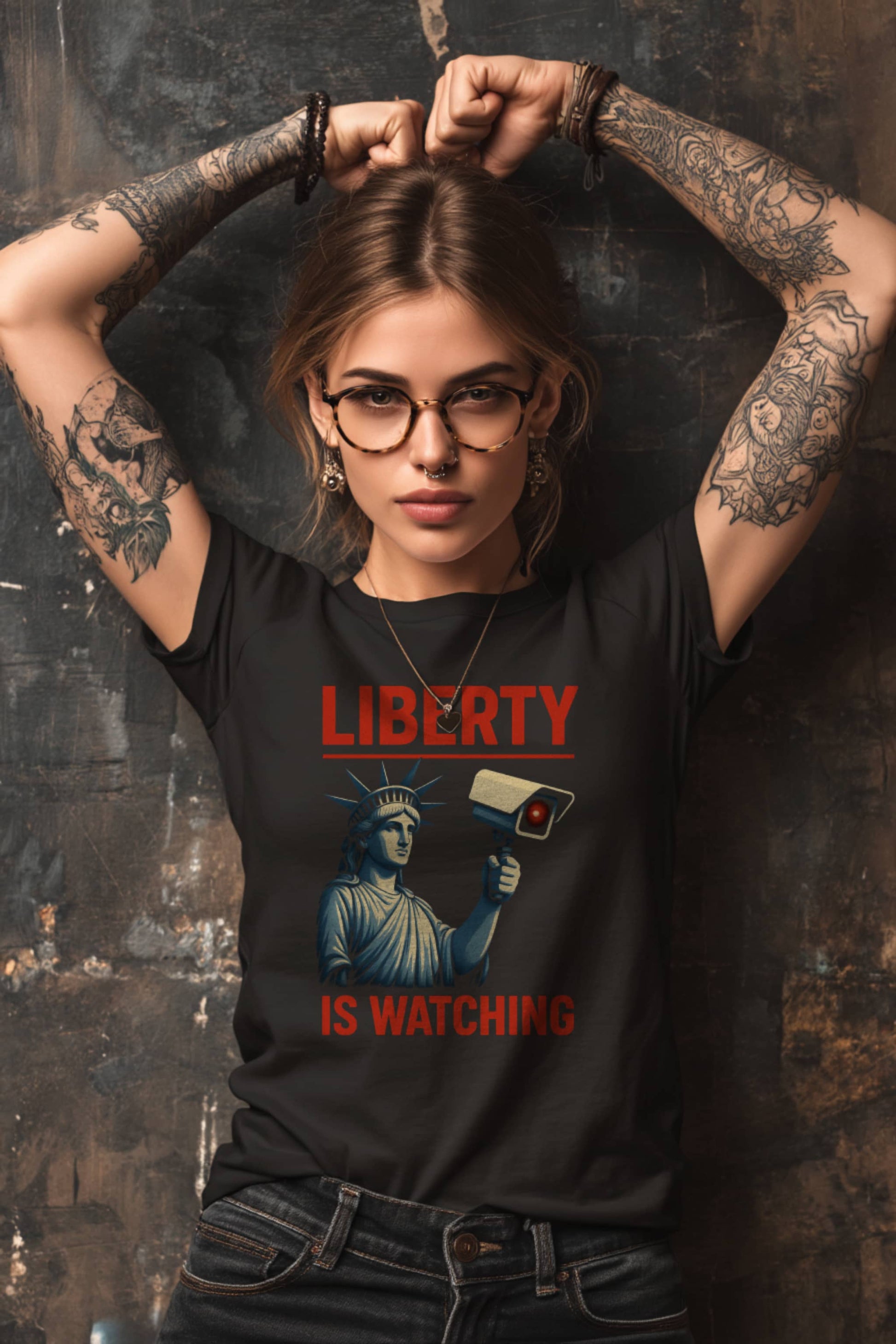 Man wearing Liberty Is Watching t-shirt in black with Statue of Liberty surveillance protest design